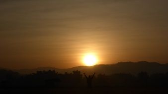 orange sun behind the mountain at sunrise