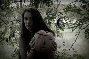 halloween pumpkin and a girl in the forest