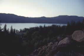 Beautiful distant view of the lake at the foot of the rocks and plants