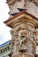 pigeons on pillar of aged fountain, slovakia, bratislava