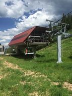 cable cars at cableway station above green hill