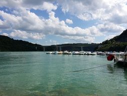 pier with boats on the lake on a sunny day