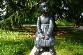 Metal girl statue in garden