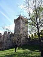 medieval castle with stone walls in the landscape of italy