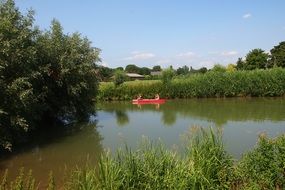Landscape with the canoe in the river in Netherlands