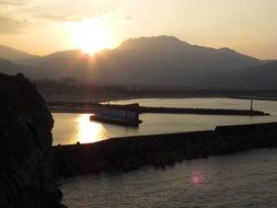 sunset over the sea with quiet water