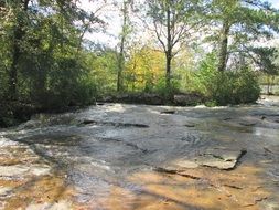 wide waterflow on rocks in forest