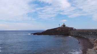 small church and cross on rosk at coast, france, collioure