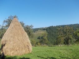 haystack on a green field