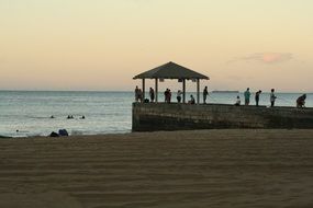 tourists at the pier on the beach in Hawaii