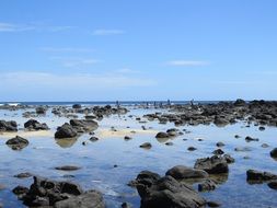 black stones in the blue ocean water