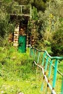 trail along the green fence in the forest