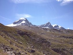 glacier in the mountains under a blue sky