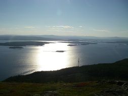 panorama of the White Sea at colorful sunrise with reflections on water