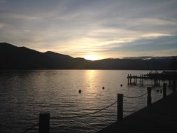 sunset over the mountains near the lake