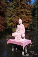 pink statue on the lake