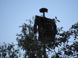 scarecrow among the trees in the garden