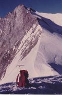 backpack and alpine hammer at snowy mountains, switzerland, valais