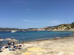 people resting on beach at seaside