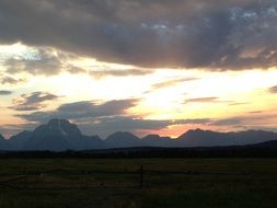 landscape of clouds above distant mountains at sunset, usa, Wyoming, Grand Teton National Park