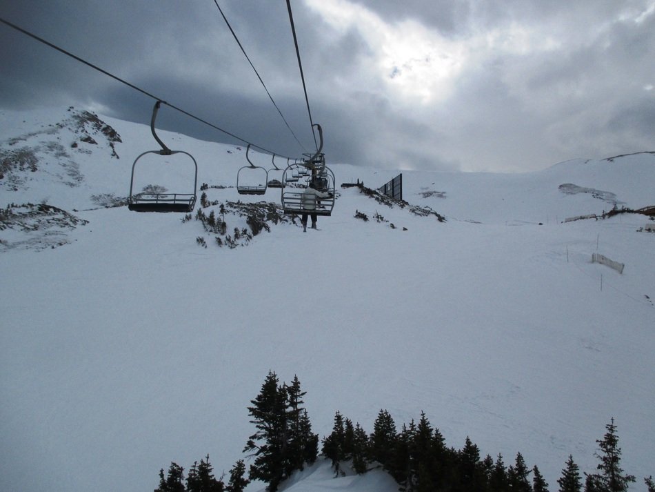 funicular over snowy mountains on a cloudy day