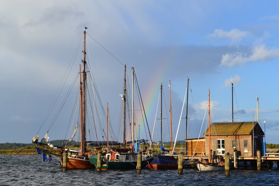 rainbow over the boats in the port