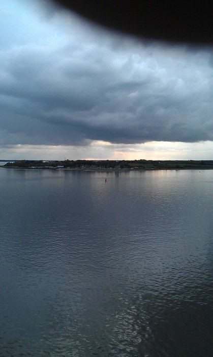 formidable clouds over water in the evening