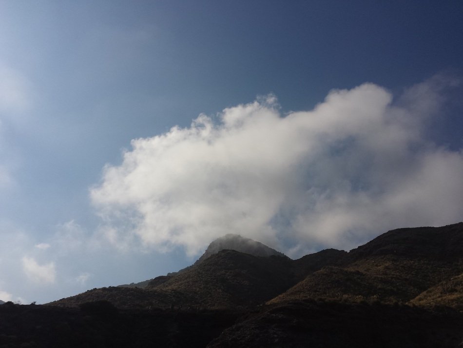 white cloud in the blue sky over the mountain