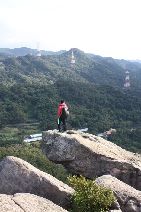 remote view of a climber on the edge of a cliff