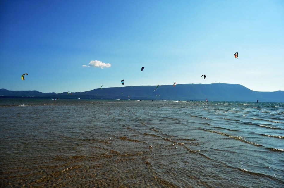 kites fly over the water