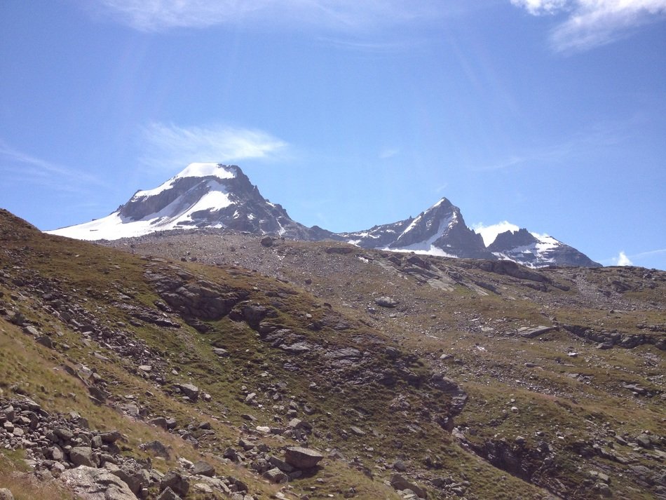 glacier in the mountains under a blue sky