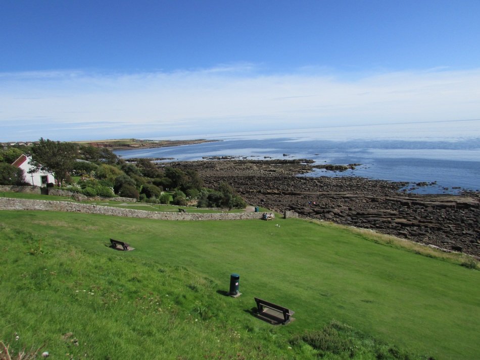 green field near the coast in Scotland
