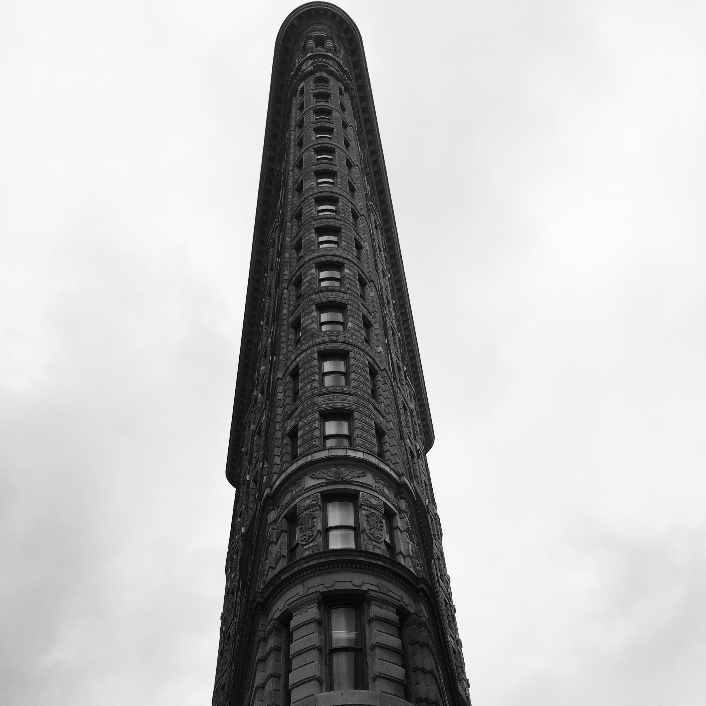 A tall narrow building at cloudy sky background in new York free image ...