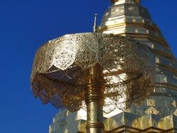 golden umbrella near the golden temple in thailand