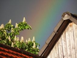 rainbow over a house roof