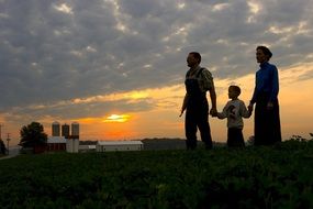 family in a farm at the sunset