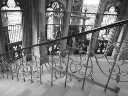 black and white photograph of a staircase with a railing in Ulm Cathedral