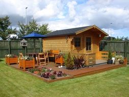 wooden hut amid a garden lawn