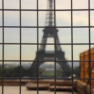 view over the fence of the Eiffel Tower