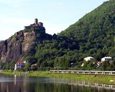 castle on rock at river, summer landscape