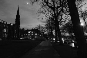 Black and white photo of street at evening time