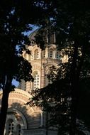 Nice church building through the green trees