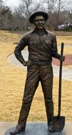 oil field worker with shovel, bronze staue in park, usa, oklahoma, oklahoma city