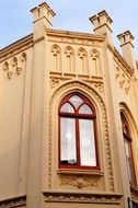 Toreutic facade of an old house with window