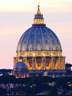 illuminated dome of st peterâs basilica at pastel colored evening sky, italy, rome, vatican