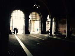 silhouettes of people near the entrance to the museum building
