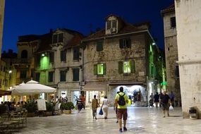 landscape of Tourists among the old night city in Croatia