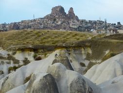 distant ancient city on tufa rock, turkey, uchisar