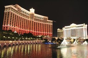 cityscape of fountains of bellagio in front of casino at night, usa, nevada, las vegas