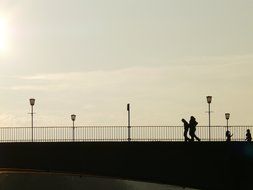 running people on a bridge